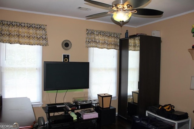 living room with ceiling fan and crown molding