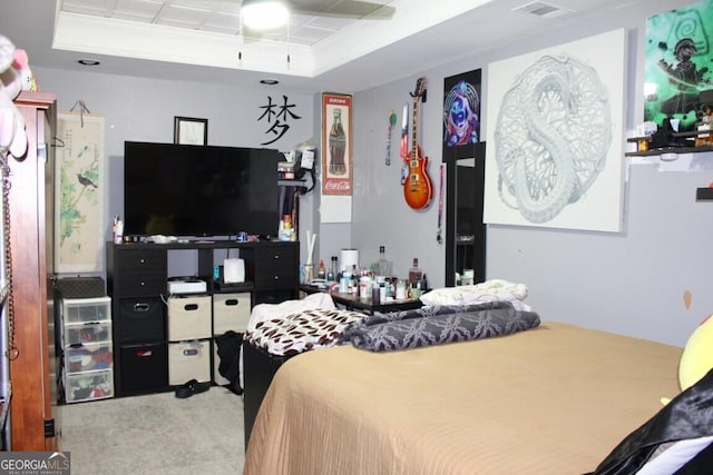 carpeted bedroom featuring ceiling fan, a raised ceiling, and ornamental molding