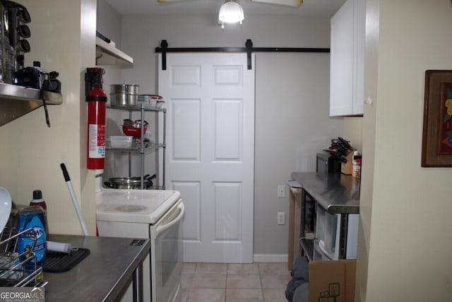 washroom featuring a barn door and light tile patterned floors