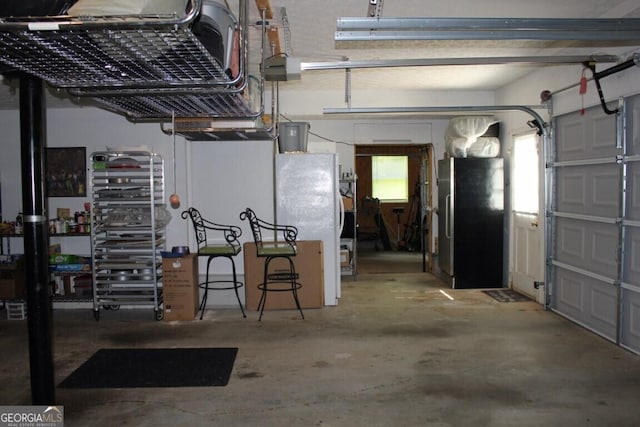 garage with stainless steel fridge and white fridge