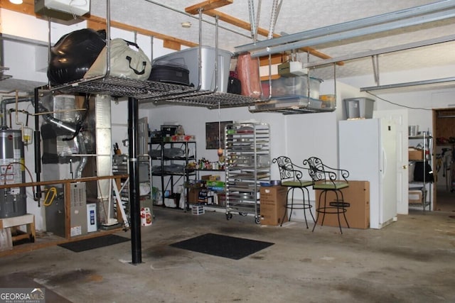 garage featuring a garage door opener, gas water heater, and white refrigerator