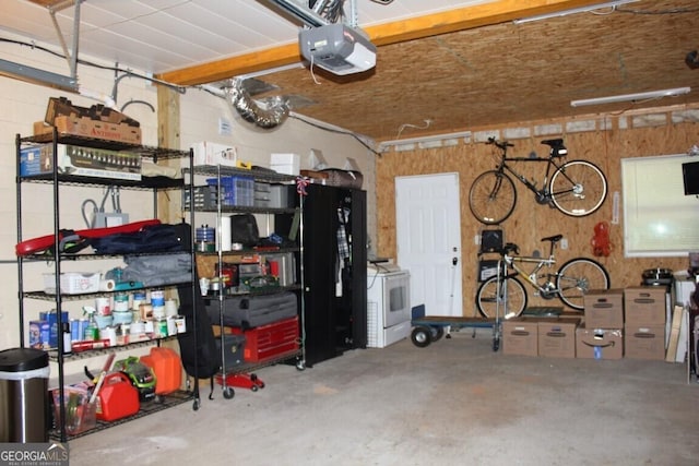 garage with washer / clothes dryer and a garage door opener