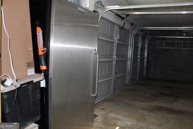 garage featuring stainless steel fridge