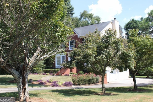 obstructed view of property featuring a front yard