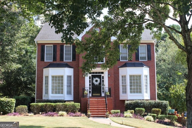 colonial-style house with a front yard