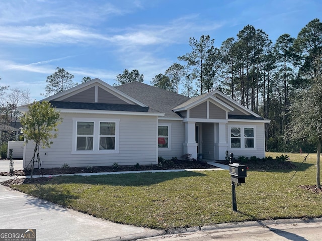 single story home with a front yard and roof with shingles