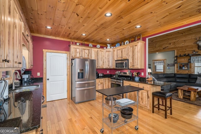 kitchen with light brown cabinets, sink, appliances with stainless steel finishes, light hardwood / wood-style floors, and wood ceiling