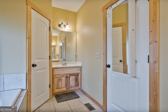 bathroom with tile patterned floors and vanity