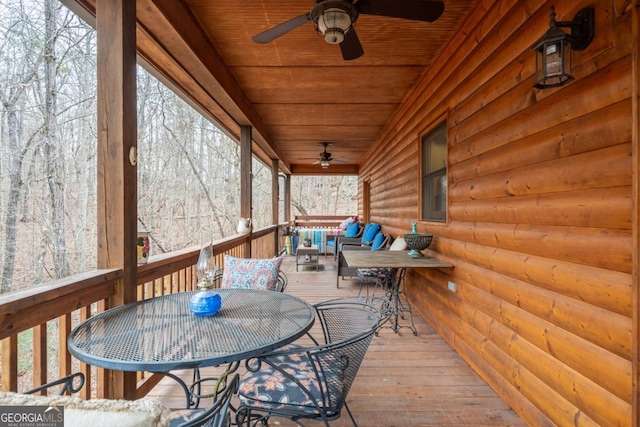 wooden terrace with outdoor lounge area and ceiling fan