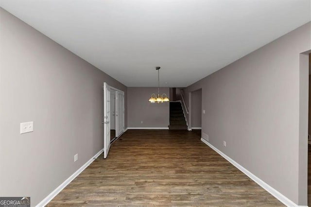 interior space featuring hardwood / wood-style floors and an inviting chandelier