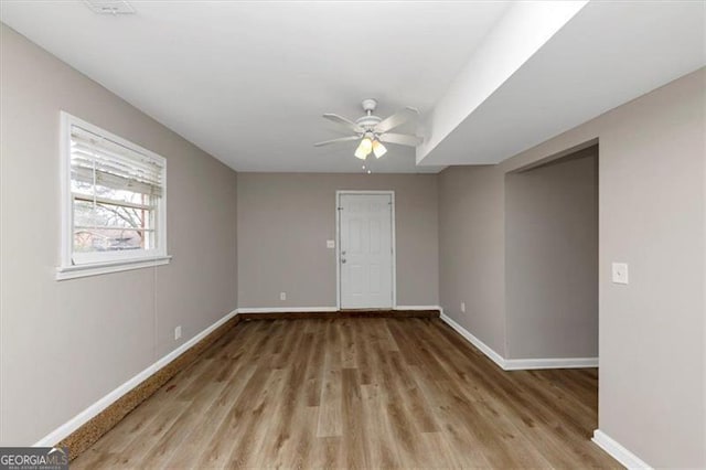 unfurnished room featuring ceiling fan and light hardwood / wood-style flooring