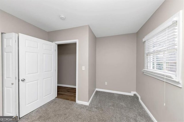 unfurnished bedroom with carpet flooring