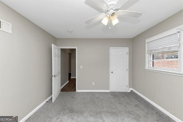 unfurnished bedroom featuring light colored carpet and ceiling fan