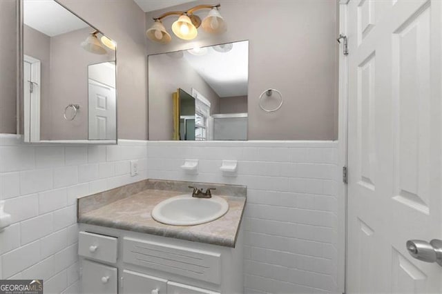 bathroom with vanity and tile walls