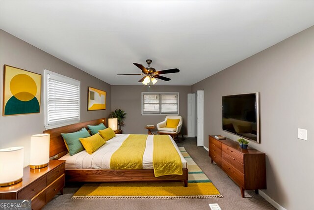 bedroom with carpet flooring, multiple windows, and ceiling fan