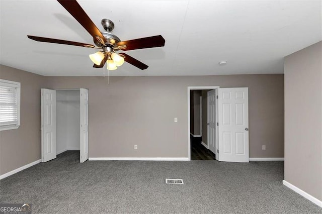 unfurnished bedroom with ceiling fan, a closet, and dark carpet