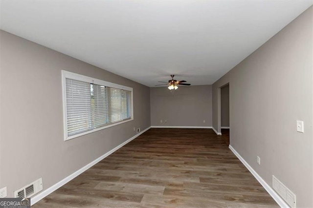 spare room featuring hardwood / wood-style flooring and ceiling fan