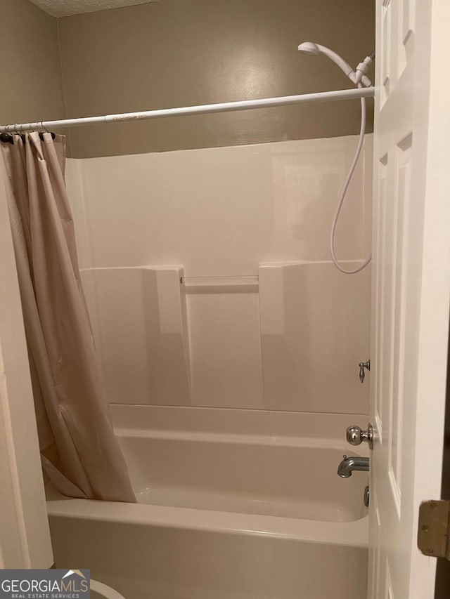 bathroom featuring shower / bathtub combination with curtain