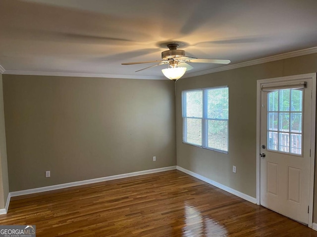 spare room with ceiling fan, crown molding, a healthy amount of sunlight, and dark hardwood / wood-style floors