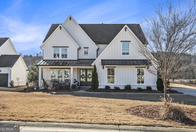 modern farmhouse style home featuring french doors and covered porch