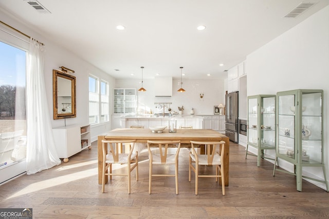 dining space featuring light hardwood / wood-style floors and plenty of natural light