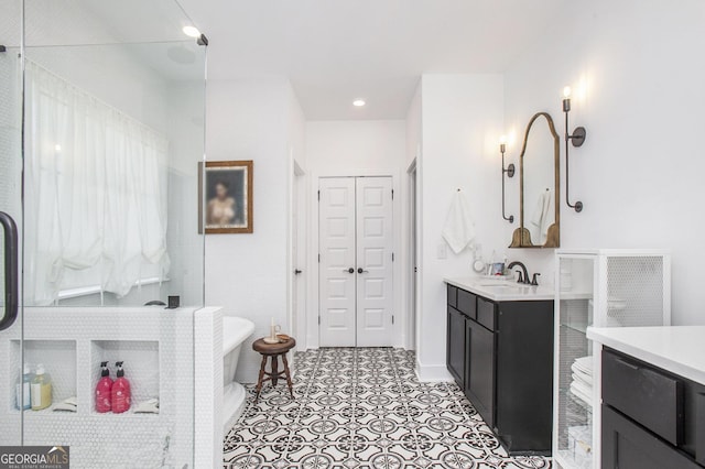 bathroom featuring a washtub and vanity