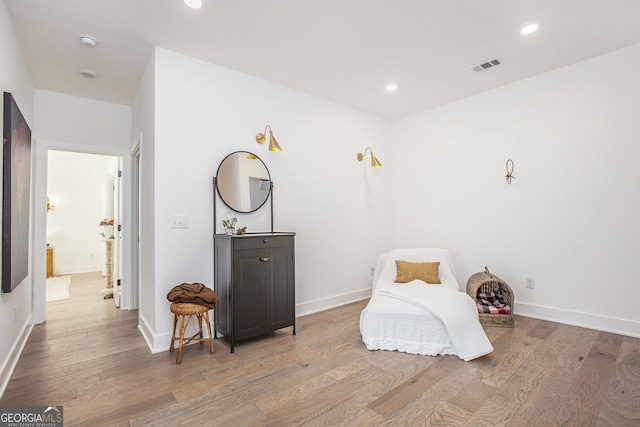 sitting room with wood-type flooring