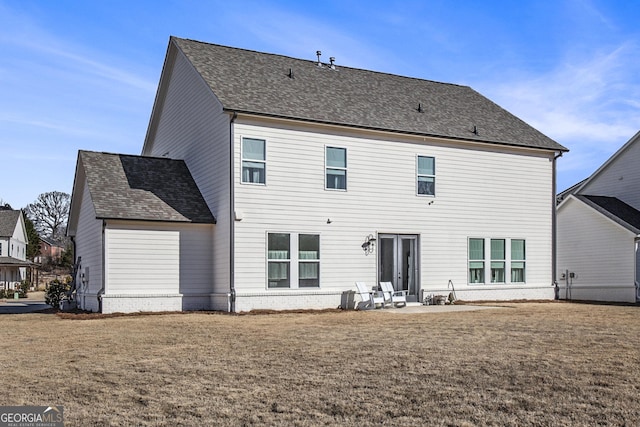 back of house with a yard and a patio