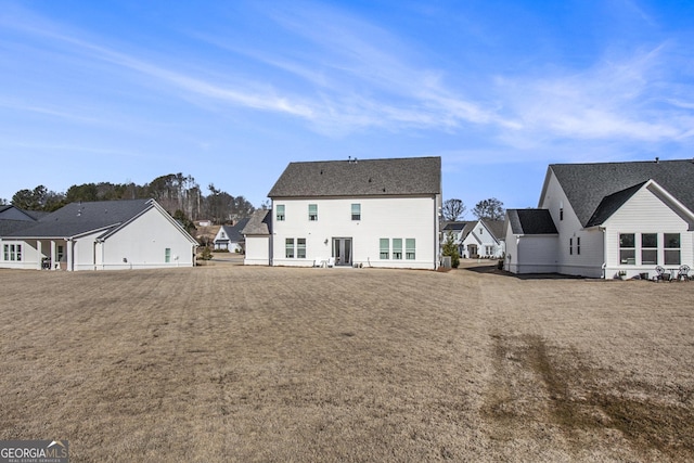 rear view of property with a lawn