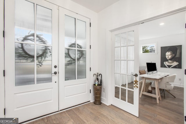 doorway to outside featuring french doors and light hardwood / wood-style floors