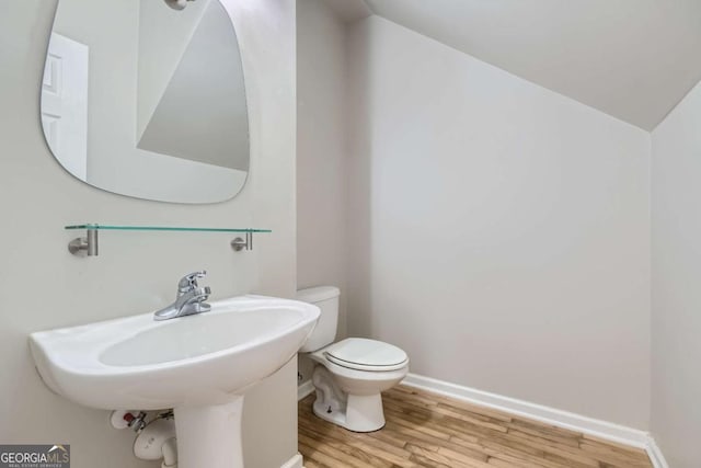 bathroom with hardwood / wood-style floors, toilet, and sink