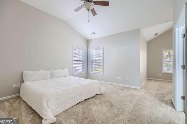 carpeted bedroom with ceiling fan and vaulted ceiling