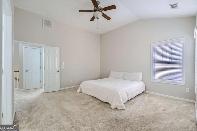 bedroom with ceiling fan, light colored carpet, and lofted ceiling