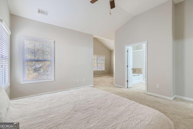 carpeted bedroom featuring ensuite bathroom, ceiling fan, lofted ceiling, and multiple windows