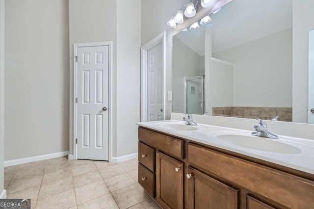 bathroom featuring tile patterned flooring, vanity, vaulted ceiling, and a shower with door