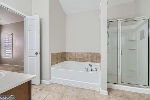 bathroom with tile patterned floors, vanity, and plus walk in shower