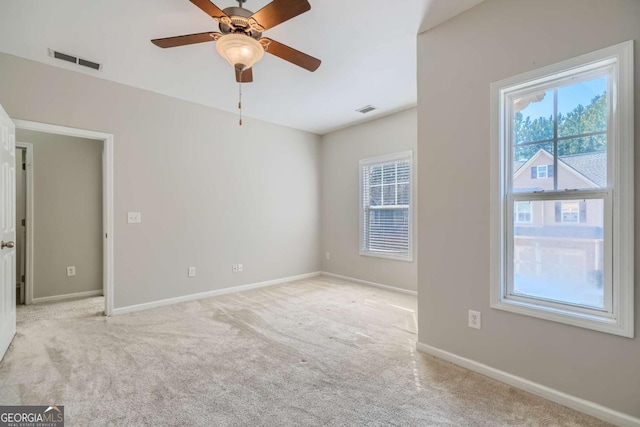 empty room featuring light carpet and ceiling fan