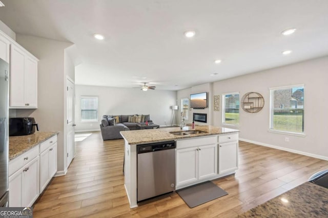 kitchen with dishwasher, white cabinets, a kitchen island with sink, and light hardwood / wood-style floors