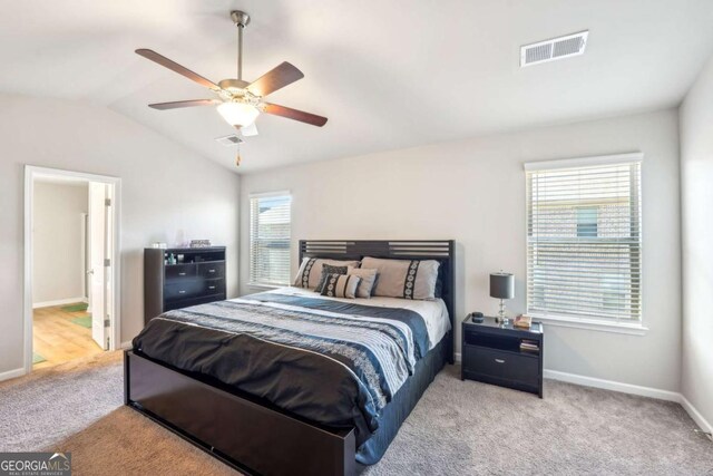 bedroom with ceiling fan, light carpet, and lofted ceiling