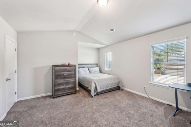 carpeted bedroom with vaulted ceiling