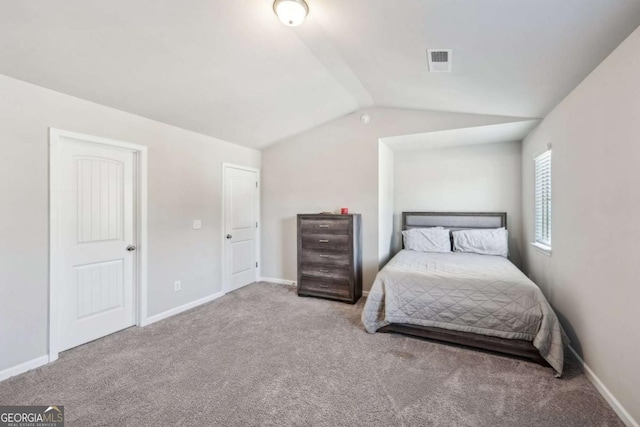 bedroom with carpet and lofted ceiling