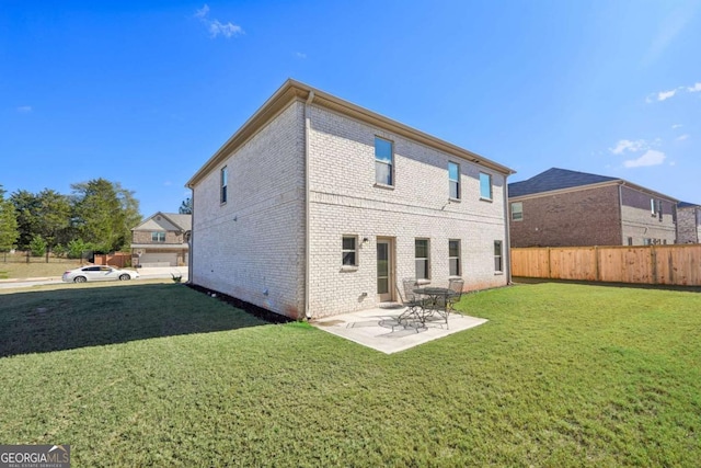 back of house with a patio area and a yard