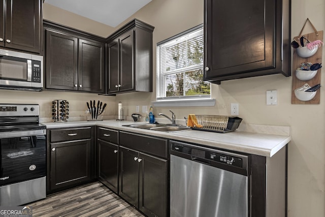 kitchen with sink, light hardwood / wood-style floors, and appliances with stainless steel finishes