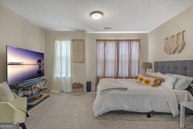 carpeted bedroom with a textured ceiling