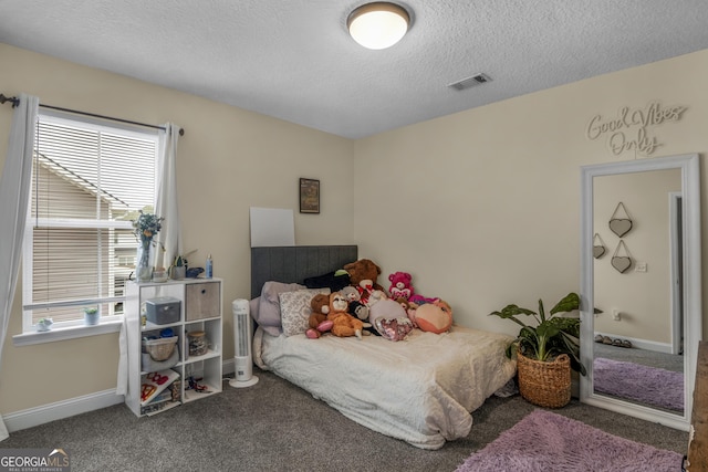 carpeted bedroom featuring a textured ceiling