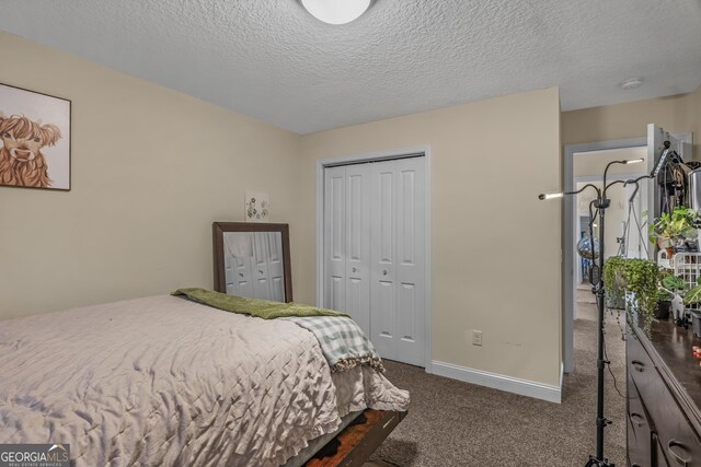 bedroom featuring dark carpet and a textured ceiling