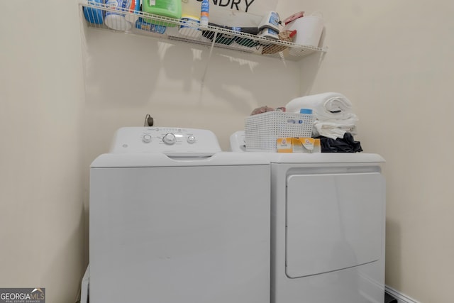 laundry room with washing machine and clothes dryer