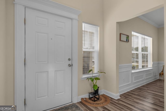 entrance foyer featuring hardwood / wood-style floors and ornamental molding