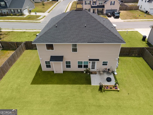 rear view of property with a patio area and a lawn