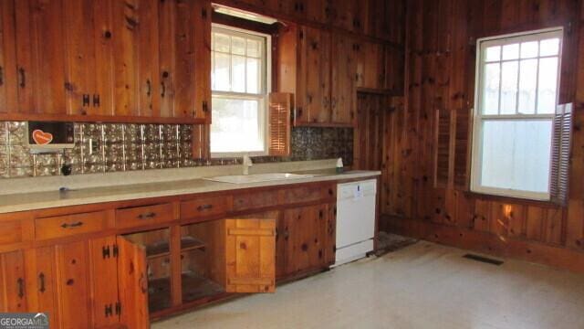 kitchen featuring white dishwasher and sink